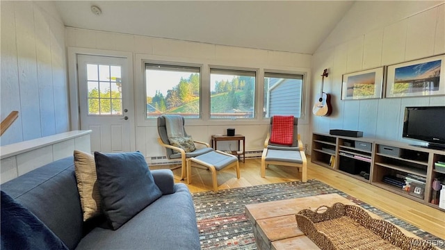 sunroom featuring a baseboard heating unit, vaulted ceiling, and a wealth of natural light