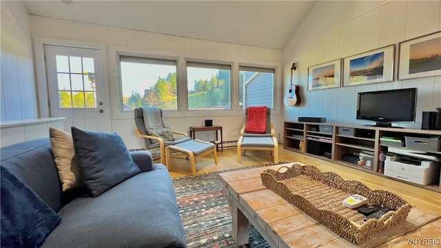 living room featuring vaulted ceiling, plenty of natural light, and wood finished floors