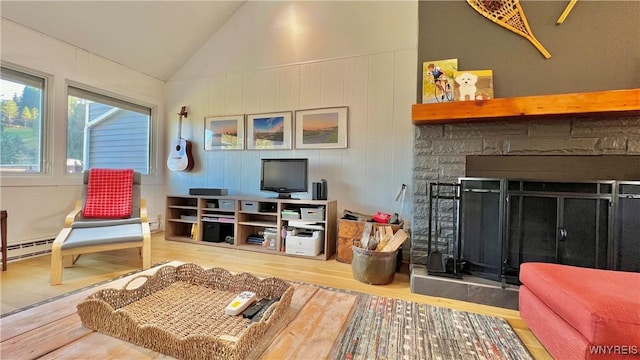 interior space with lofted ceiling, a baseboard radiator, wood finished floors, a fireplace, and a baseboard heating unit