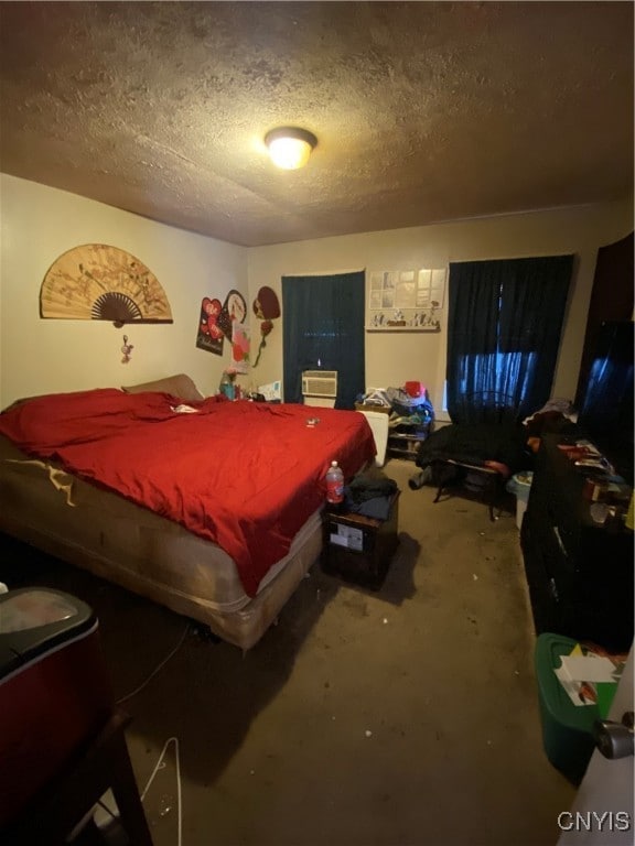 bedroom with concrete flooring and a textured ceiling