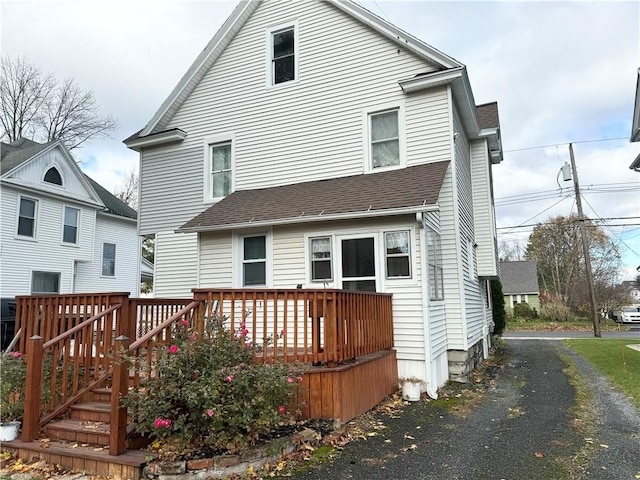 rear view of house featuring a deck