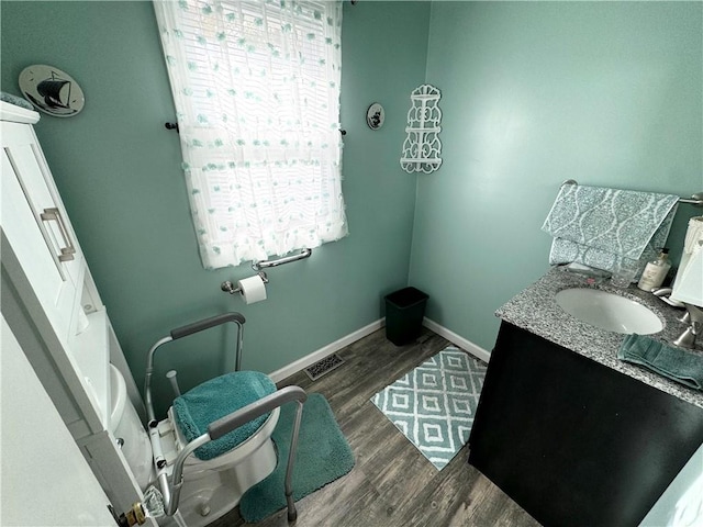 bathroom featuring hardwood / wood-style flooring, vanity, and toilet