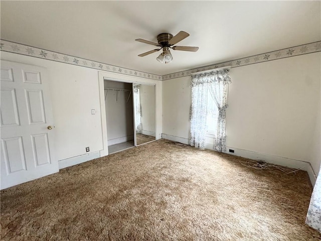 unfurnished bedroom with carpet flooring, a closet, and ceiling fan