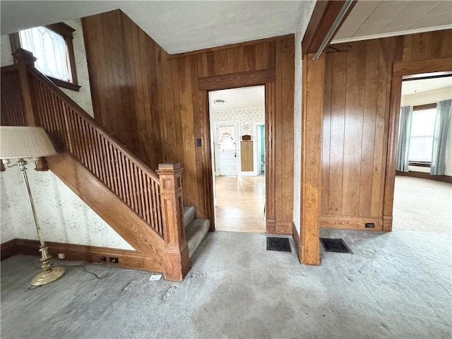 interior space featuring wood walls and a baseboard radiator