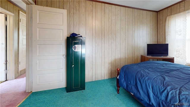 bedroom with wooden walls, carpet flooring, and ornamental molding