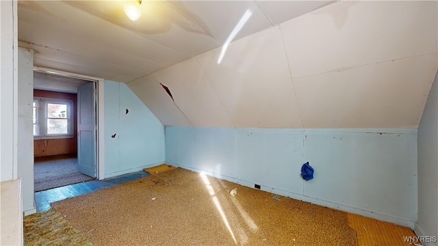 additional living space featuring lofted ceiling