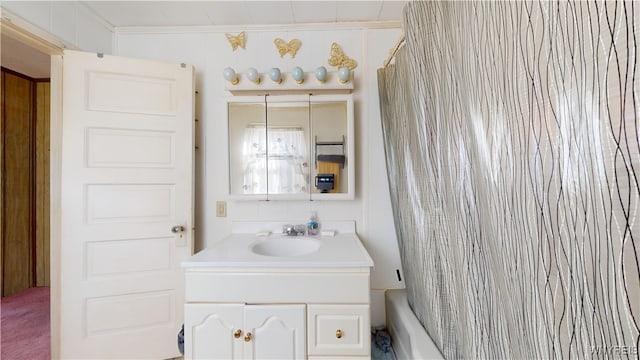 bathroom with vanity, crown molding, and shower / bathtub combination with curtain