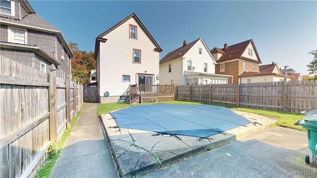 view of pool featuring a wooden deck and a patio area