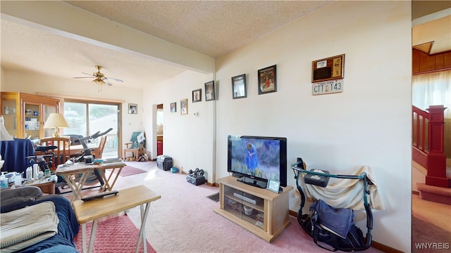 carpeted living room with a textured ceiling, ceiling fan, and beam ceiling