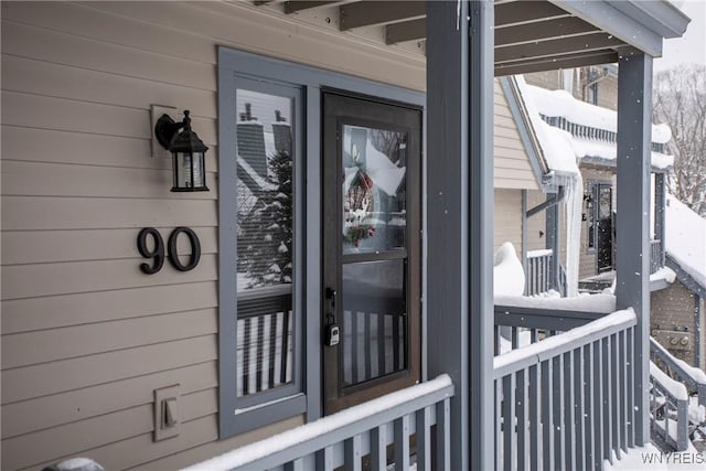 view of snow covered property entrance