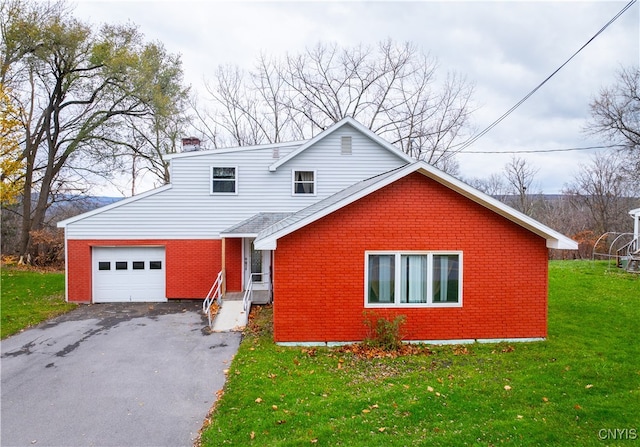 view of front of property featuring a garage and a front lawn