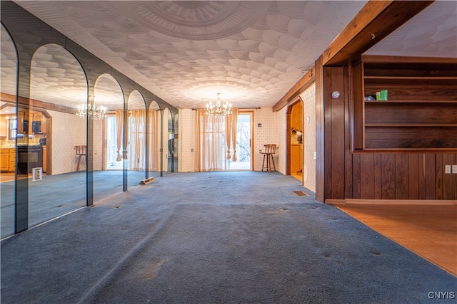 interior space with a notable chandelier and wooden walls