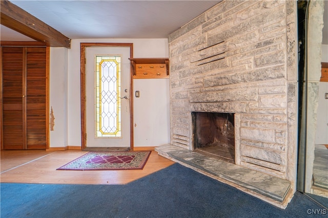 entryway with a fireplace and hardwood / wood-style flooring