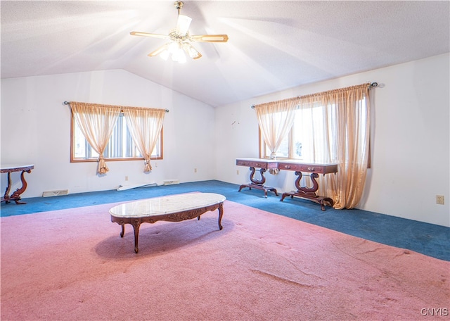 interior space with ceiling fan, lofted ceiling, and carpet