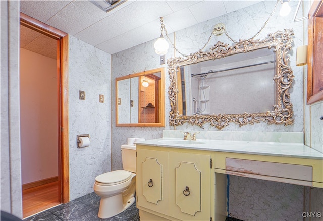 bathroom featuring toilet, vanity, and tile patterned floors