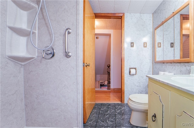 bathroom featuring tile patterned flooring, vanity, and toilet