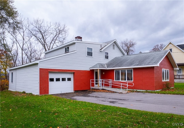 front facade with a garage and a front yard