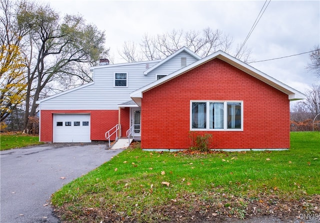 front of property with a garage and a front lawn