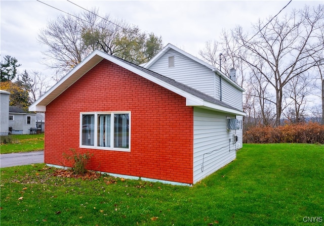 view of side of home with a yard