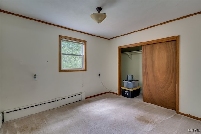 unfurnished bedroom featuring light colored carpet, crown molding, a closet, and a baseboard heating unit