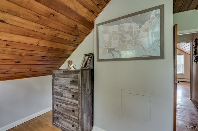 room details with hardwood / wood-style floors, a baseboard radiator, and wood ceiling