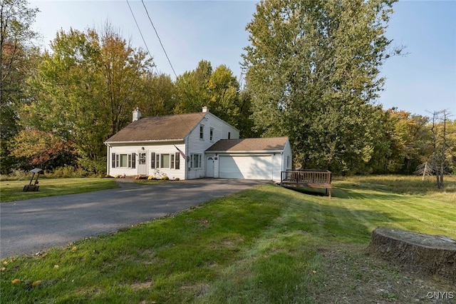 exterior space featuring a garage, a front yard, and a wooden deck