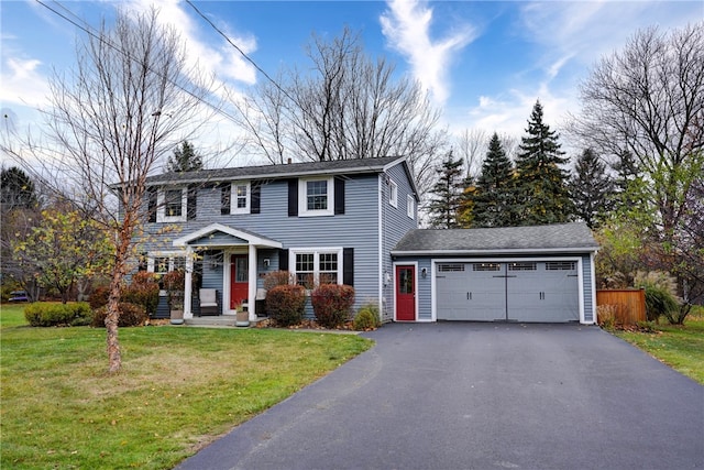 view of front of home with a front lawn and a garage