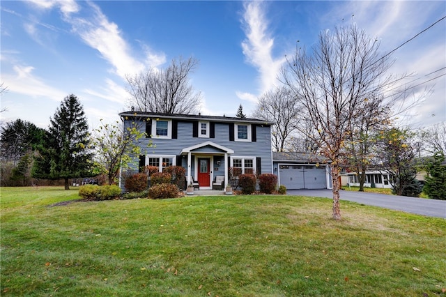 view of front facade with a front yard and a garage