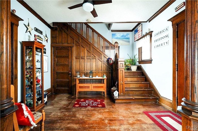 interior space featuring a textured ceiling, hardwood / wood-style flooring, ceiling fan, and crown molding