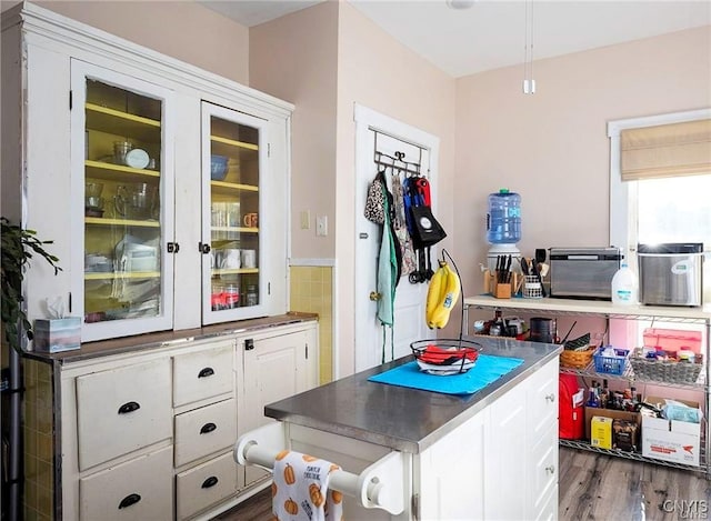 interior space featuring white cabinets and dark hardwood / wood-style flooring