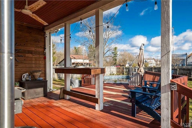 deck with a pool and ceiling fan