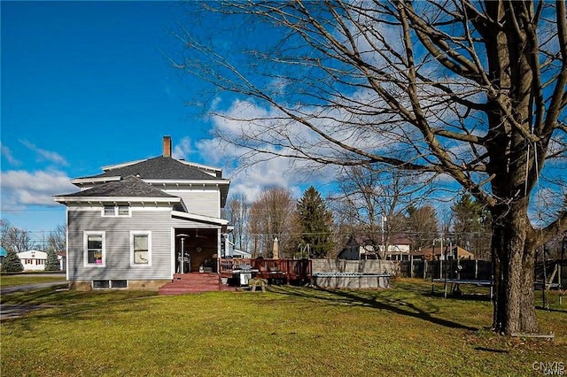 exterior space with a trampoline and a lawn