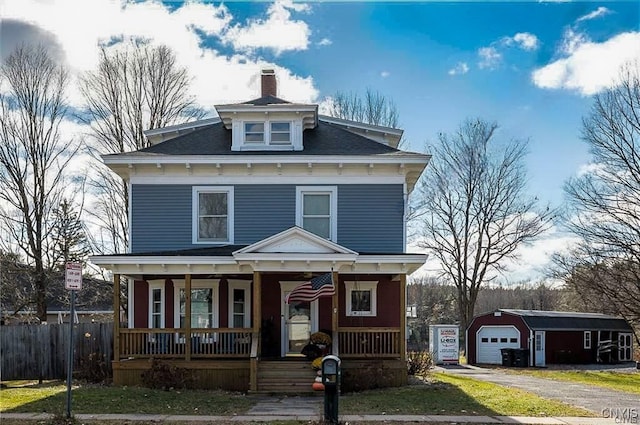 view of front facade with a garage, covered porch, and an outdoor structure