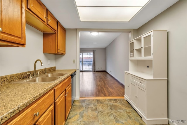 kitchen featuring hardwood / wood-style flooring, stainless steel dishwasher, and sink