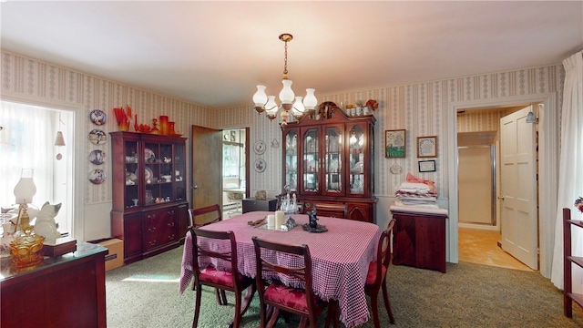 dining area featuring light colored carpet and an inviting chandelier