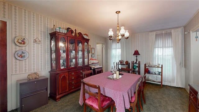 dining space featuring dark colored carpet and a notable chandelier