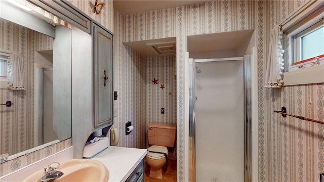 bathroom with toilet, vanity, and walk in shower