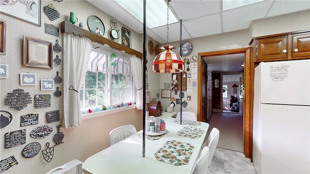 dining room with a drop ceiling