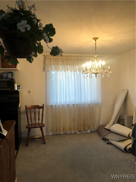 dining area featuring carpet and a chandelier