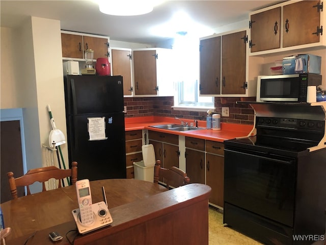 kitchen with black appliances, decorative backsplash, and sink