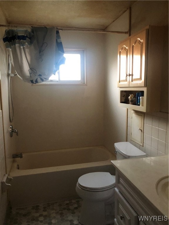 full bathroom featuring vanity, tile patterned flooring, decorative backsplash, toilet, and tub / shower combination