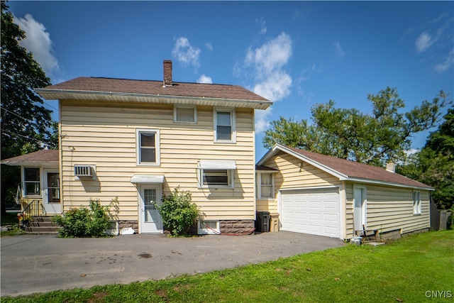 view of front of house featuring a front yard and a garage