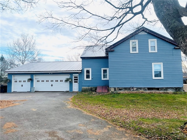 exterior space featuring a front lawn and a garage