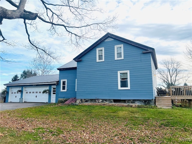 view of property exterior with a yard and a garage