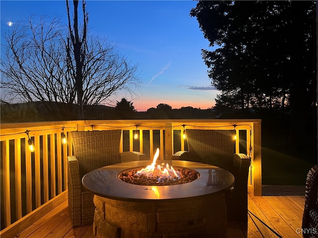 deck at dusk with an outdoor fire pit