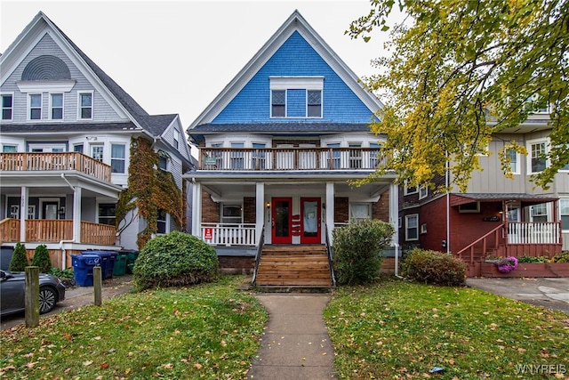 victorian home featuring covered porch and a balcony