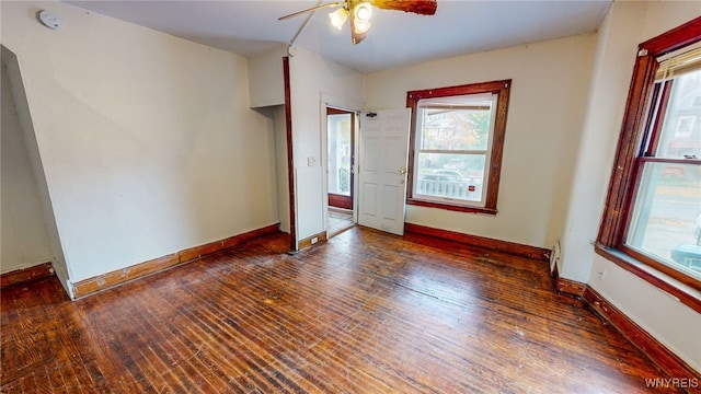 unfurnished bedroom featuring ceiling fan and dark hardwood / wood-style floors