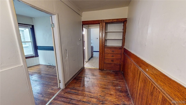 hall featuring dark hardwood / wood-style flooring and radiator heating unit