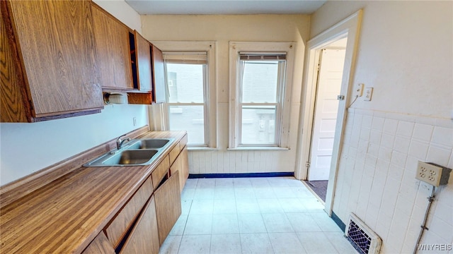 kitchen with tile walls and sink