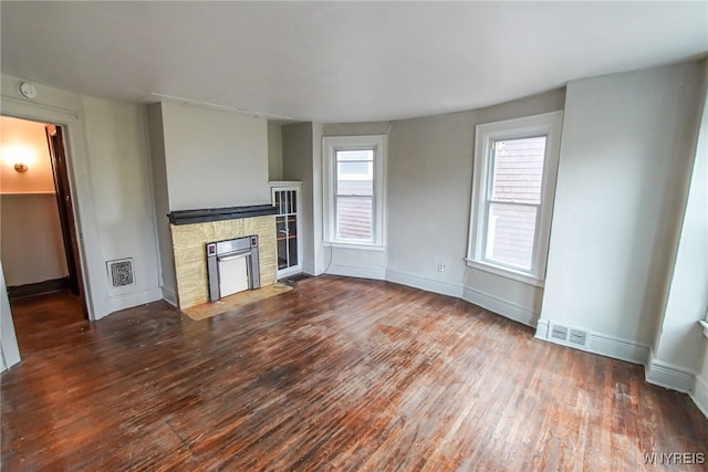 unfurnished living room with dark hardwood / wood-style flooring